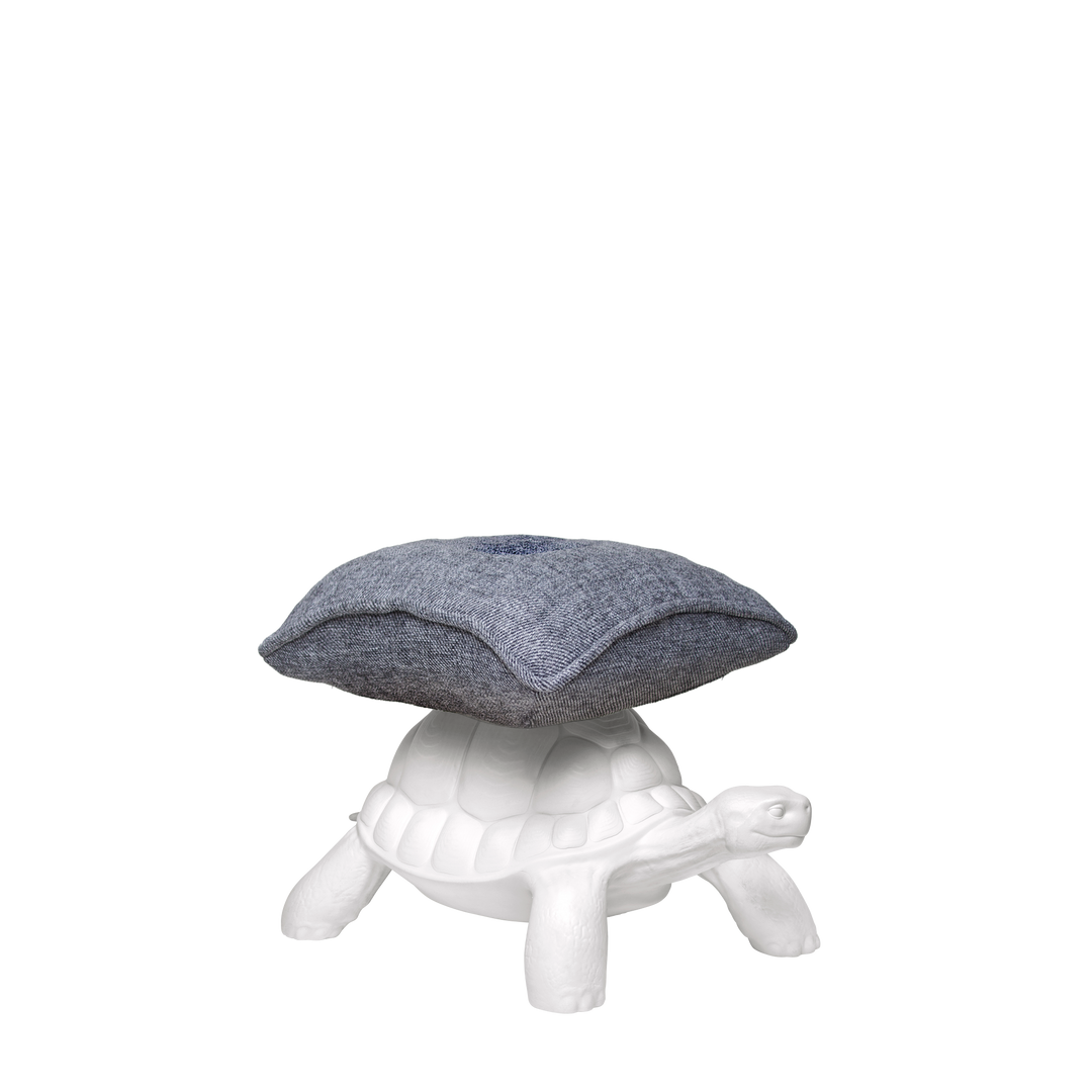 White ceramic turtle pouf with a textured grey cushion, contemporary accent seating