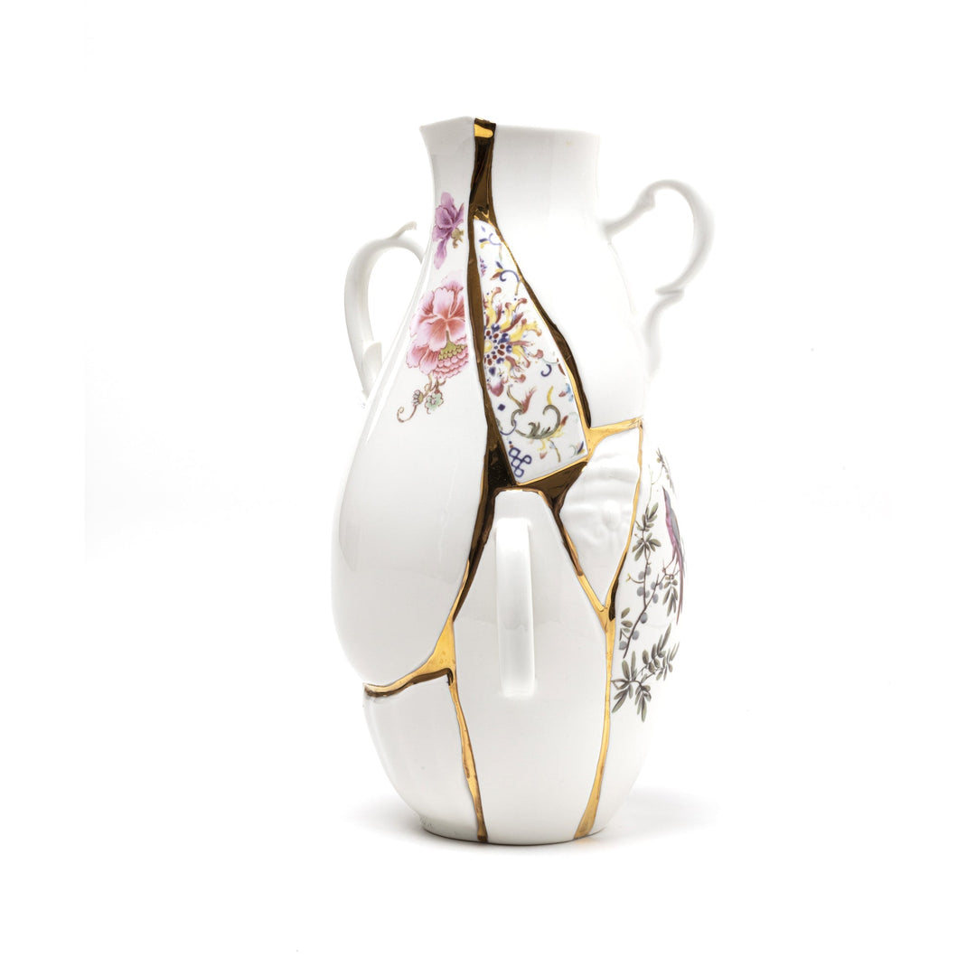 Porcelain kintsugi vase with gold-repaired seams and delicate floral motifs