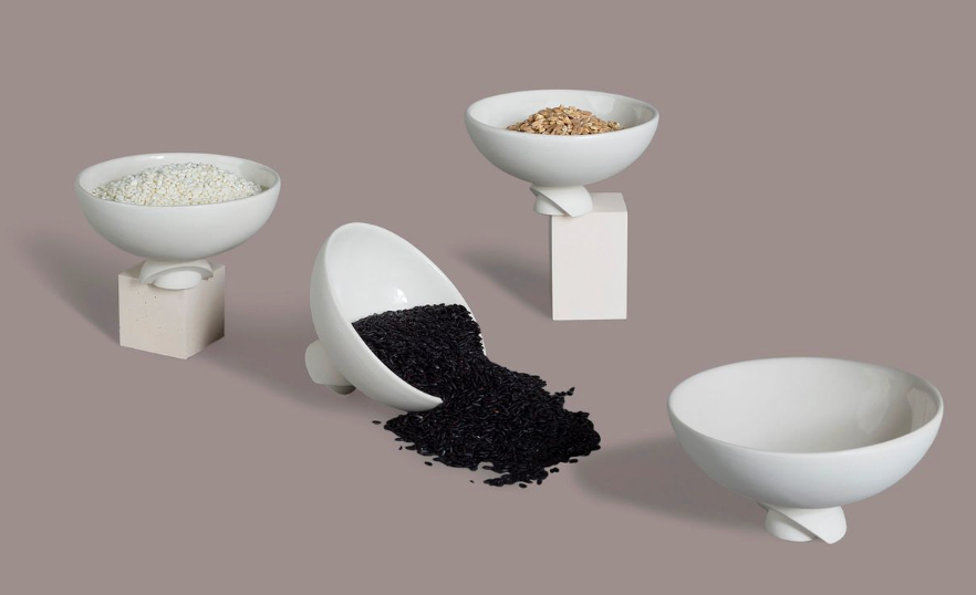 Elegant sculptural porcelain bowls with unique pedestal base on neutral backdrop