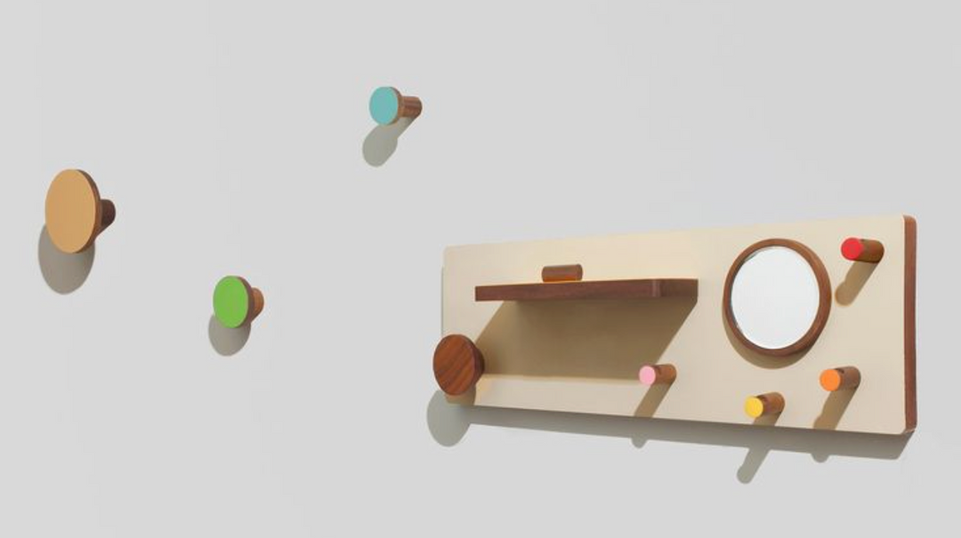 Modern wood wall shelf with circular mirror and colorful peg hooks, minimalist decor