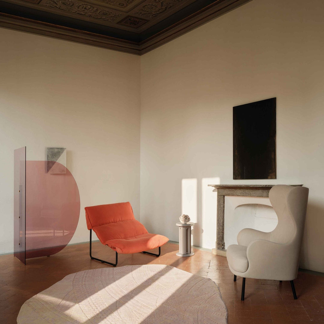 Arflex Taboga lounge chair by Cini Boeri in coral fabric, modern partition, and neutral armchair in refined living space