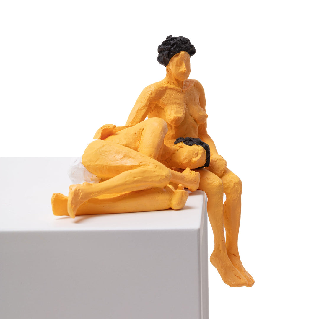 Seletti Love Is a Verb Theo &amp; Elena Figurine, front view of the embracing pair at the edge of a block