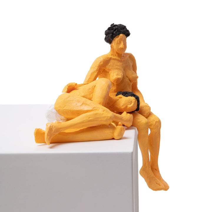 Seletti Love Is a Verb Theo &amp; Elena Figurine, front view of the embracing pair at the edge of a block