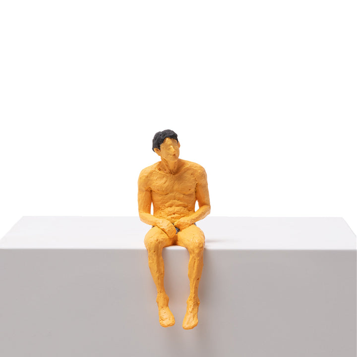 Seletti Love Is a Verb Alberto Figurine, ochre resin man in black briefs sitting on a ledge, legs dangling
