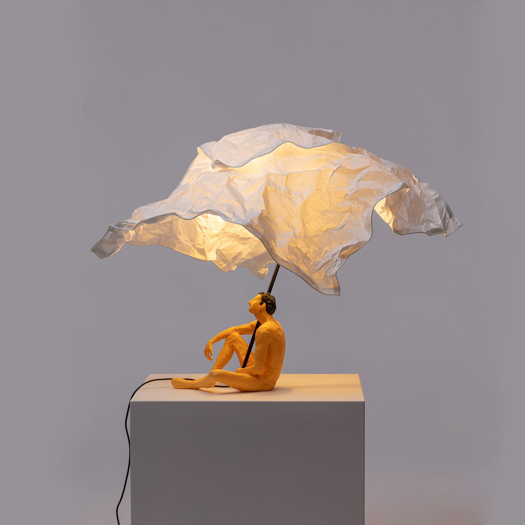 Seletti Love Is a Verb Lamp Roby, the paper canopy lit warm above the figure