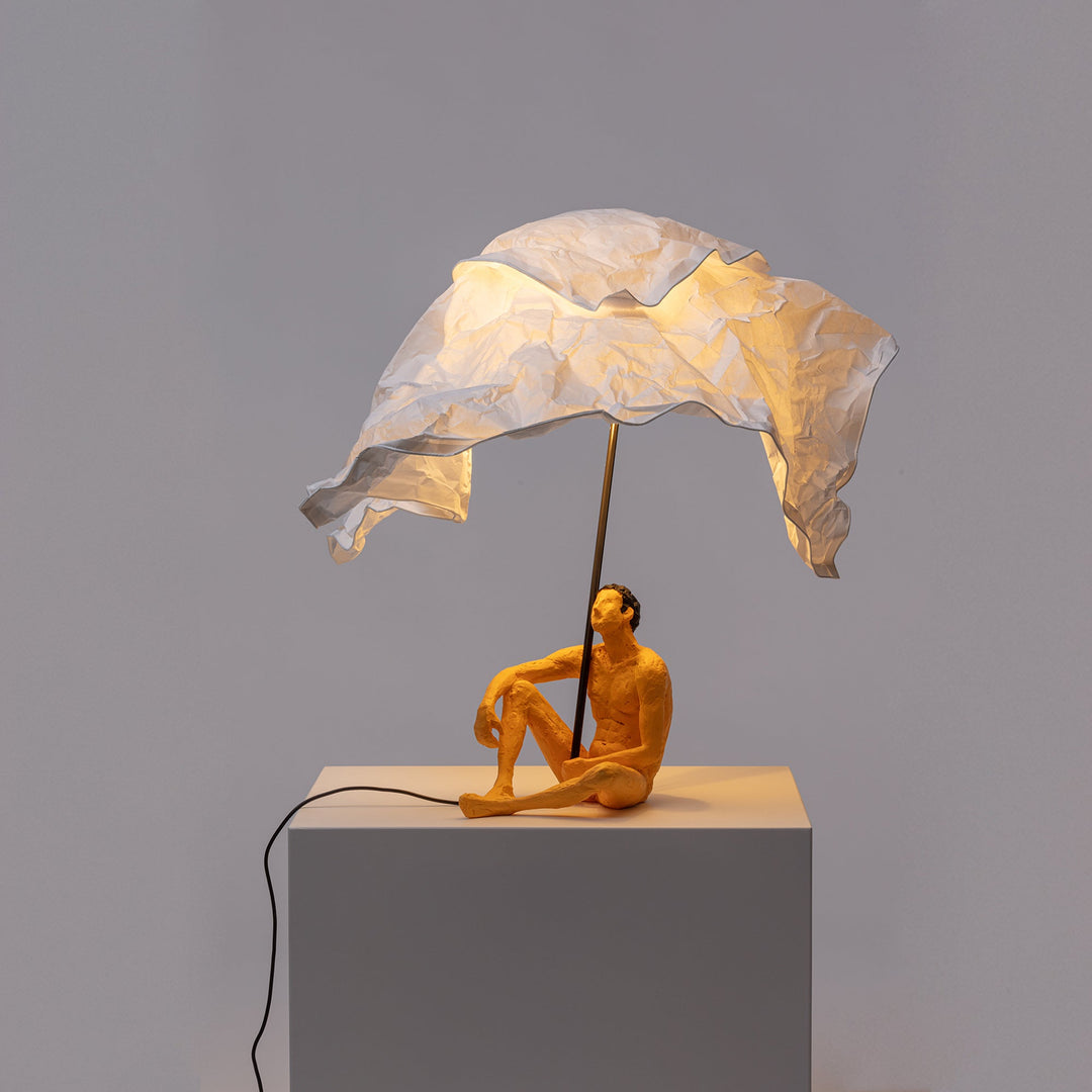 Seletti Love Is a Verb Lamp Roby, lit lamp seen from the side against gray