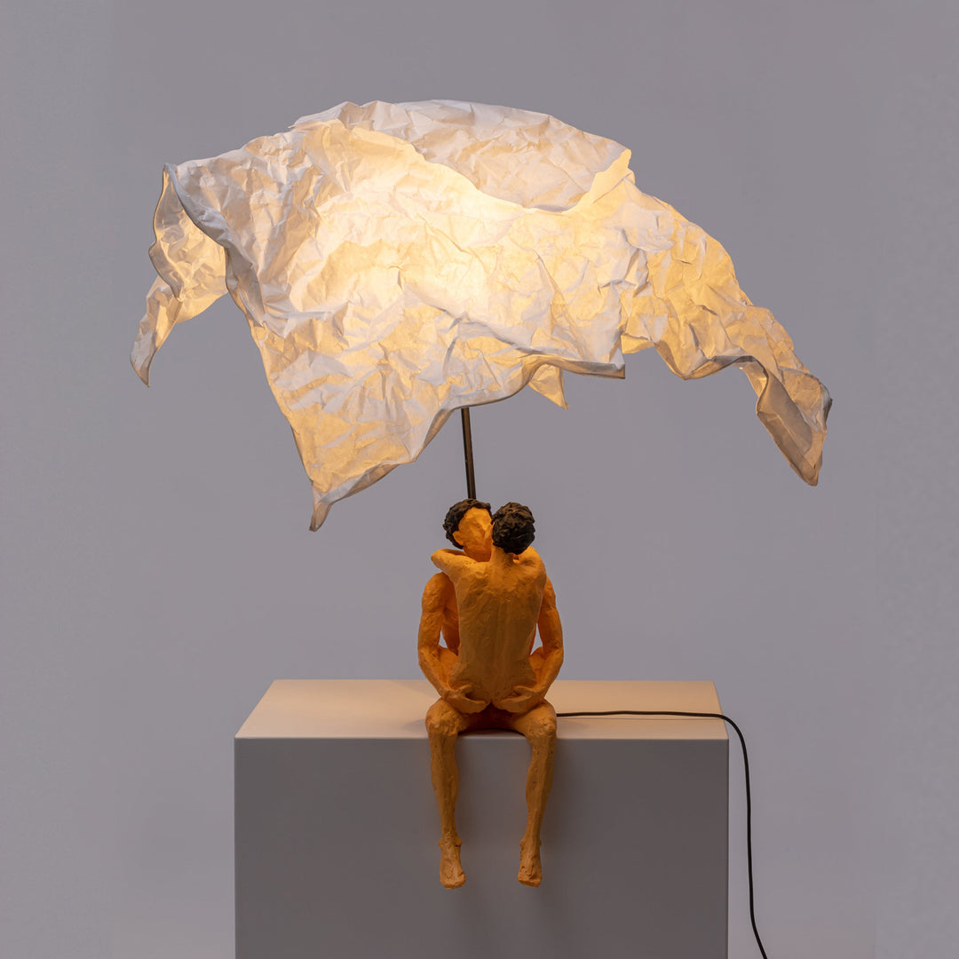 Seletti Love Is a Verb Lamp Max &amp; Roberta, the paper shade glowing warm over the seated pair