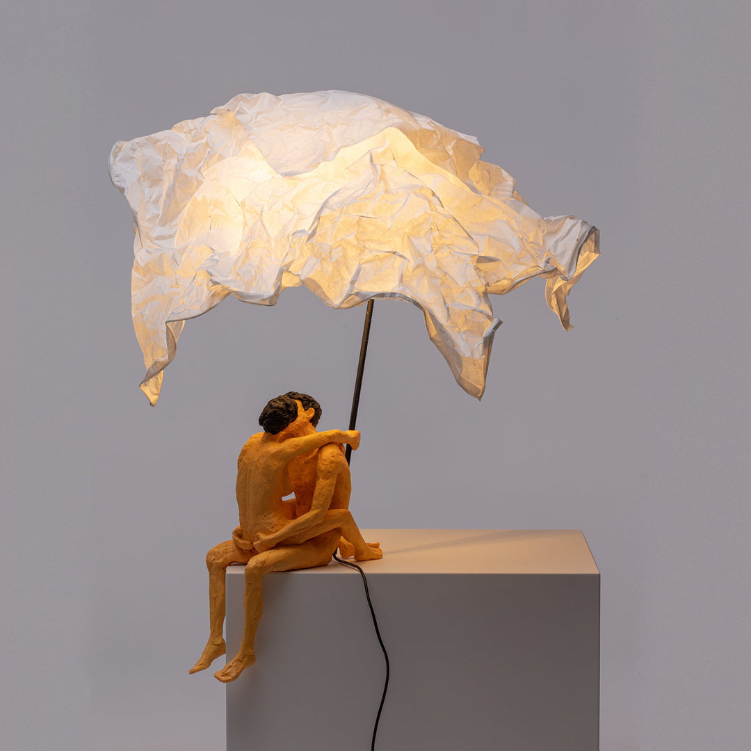 Seletti Love Is a Verb Lamp Max &amp; Roberta, lit lamp on a gray plinth, light falling on the figures