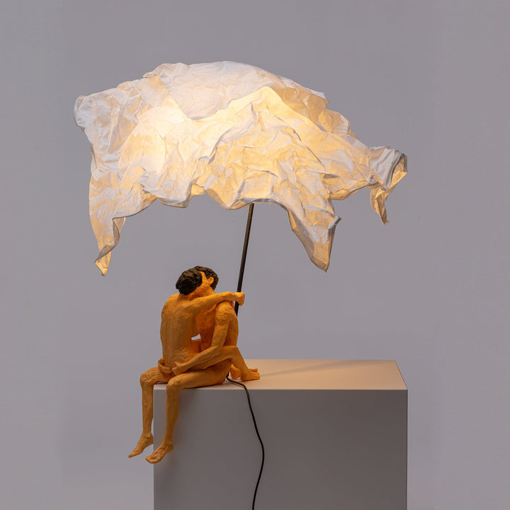 Seletti Love Is a Verb Lamp Max &amp; Roberta, lit lamp on a gray plinth, light falling on the figures