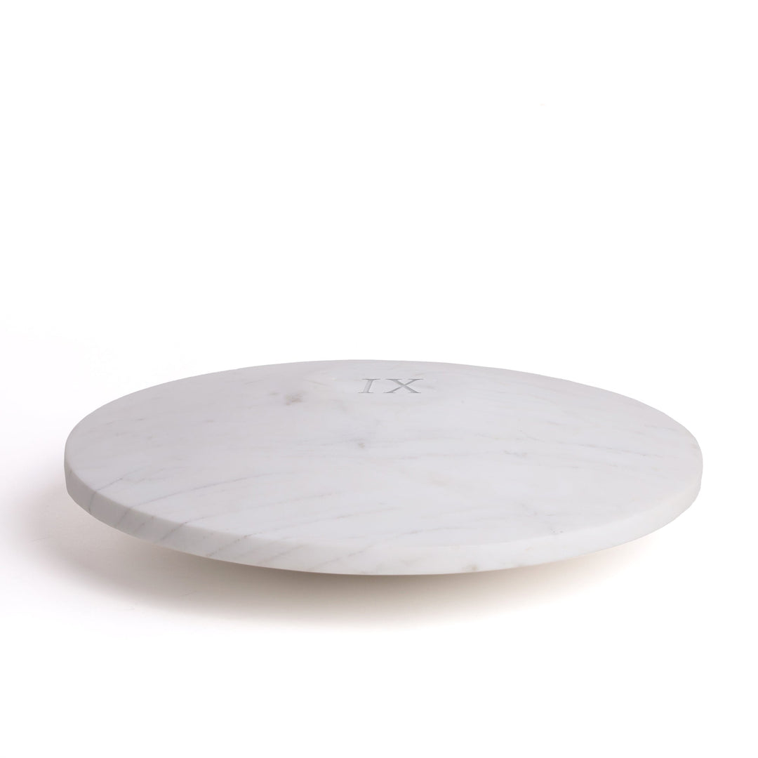 Seletti Lvdis Marble Weight Disk, white marble weight disk engraved with the Roman numeral IX, angled view