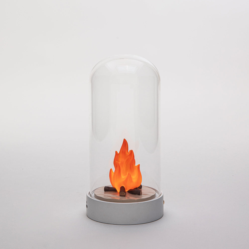 Seletti My Little Bonfire, the bonfire lamp on a gray backdrop, flames glowing softly