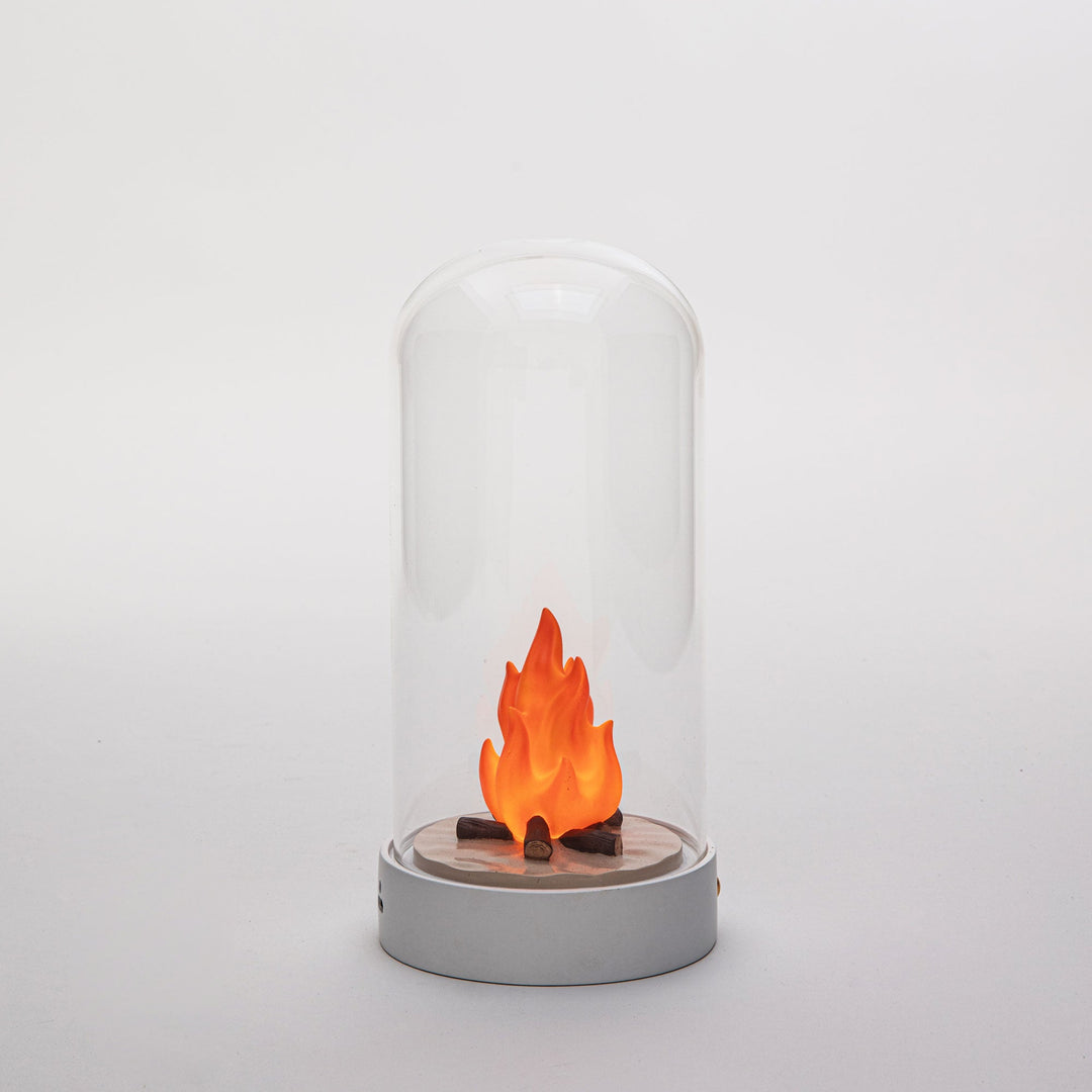 Seletti My Little Bonfire, the bonfire lamp on a gray backdrop, flames glowing softly