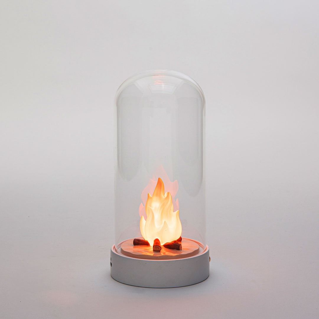 Seletti My Little Bonfire, the lit campfire glowing orange inside the dome