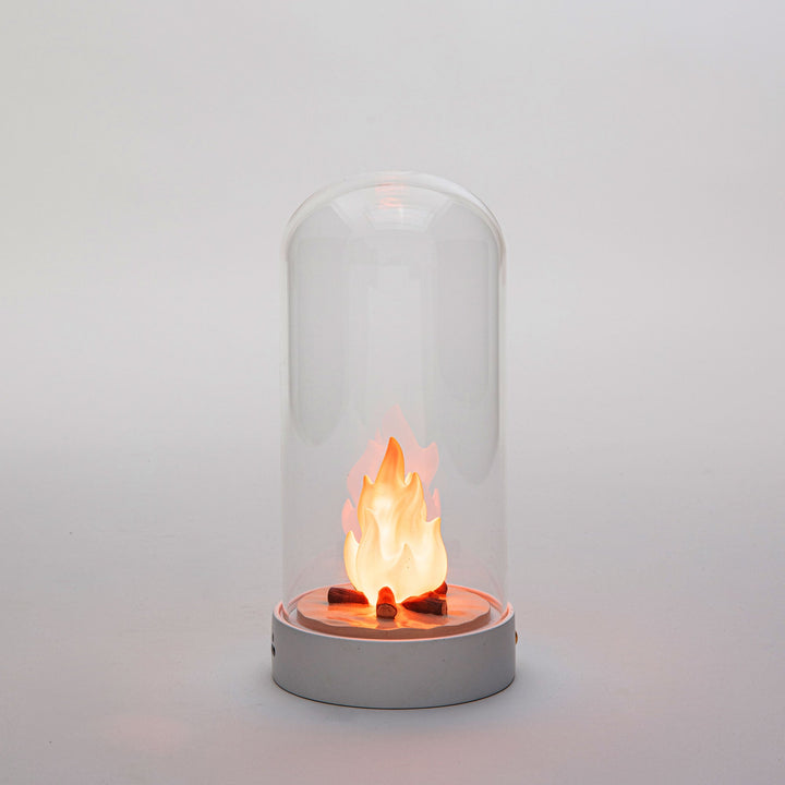 Seletti My Little Bonfire, the lit campfire glowing orange inside the dome