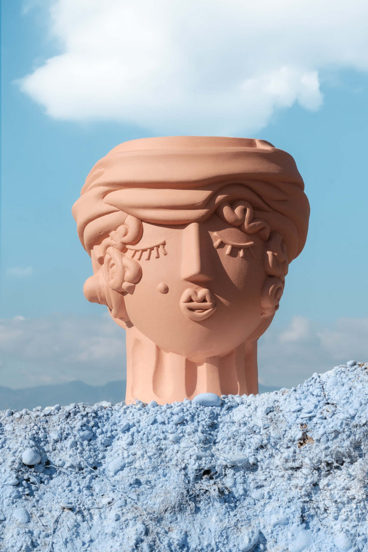 Seletti Magna Graecia Terracotta Head Vase Woman, the vase on blue rock under clouds
