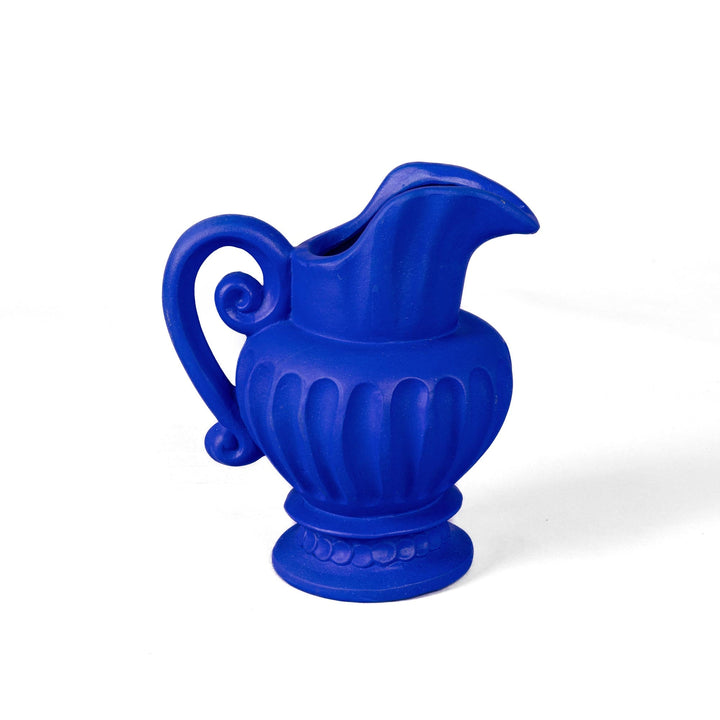 Seletti Magna Graecia Terracotta Caraffa Blue, cobalt blue fluted jug with a scrolled handle on a pedestal foot