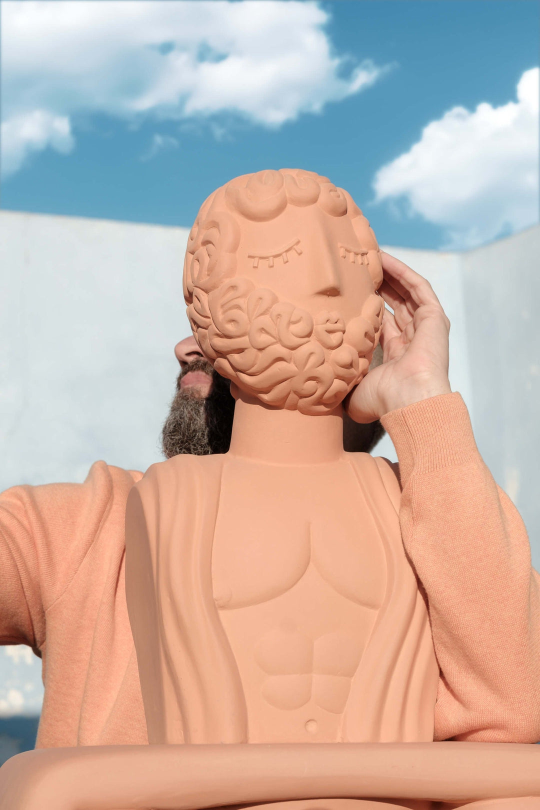 Seletti Magna Graecia Terracotta Bust Man, the bust held up against a summer sky