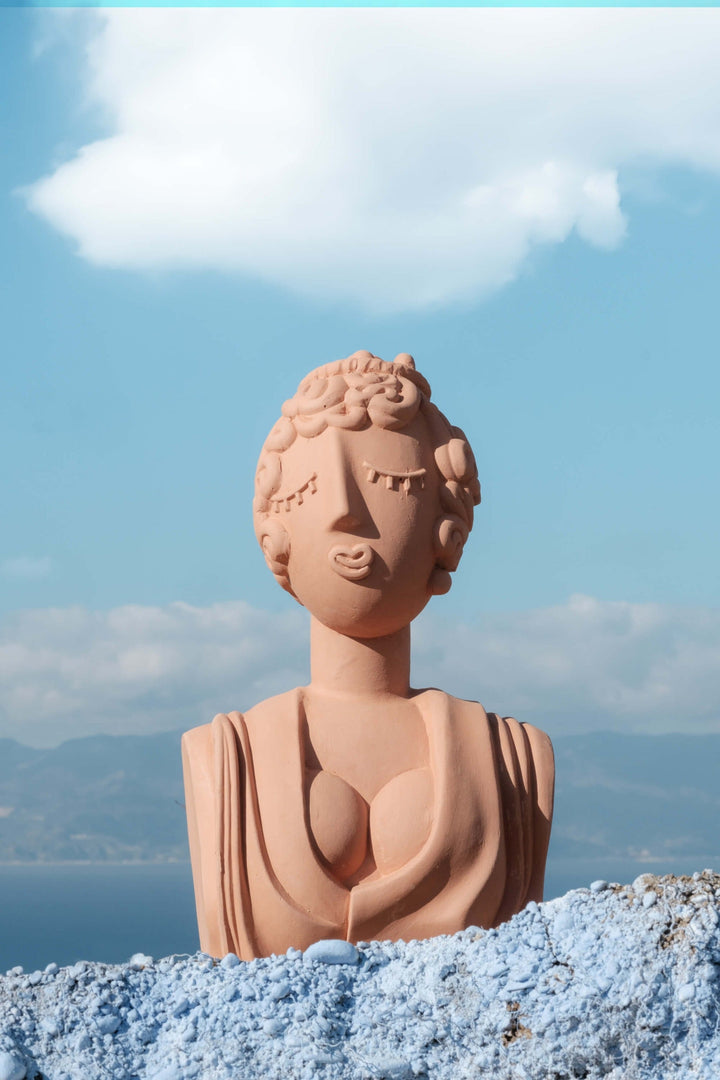 Seletti Magna Graecia Terracotta Bust Poppea, the bust against blue sky and Mediterranean coast