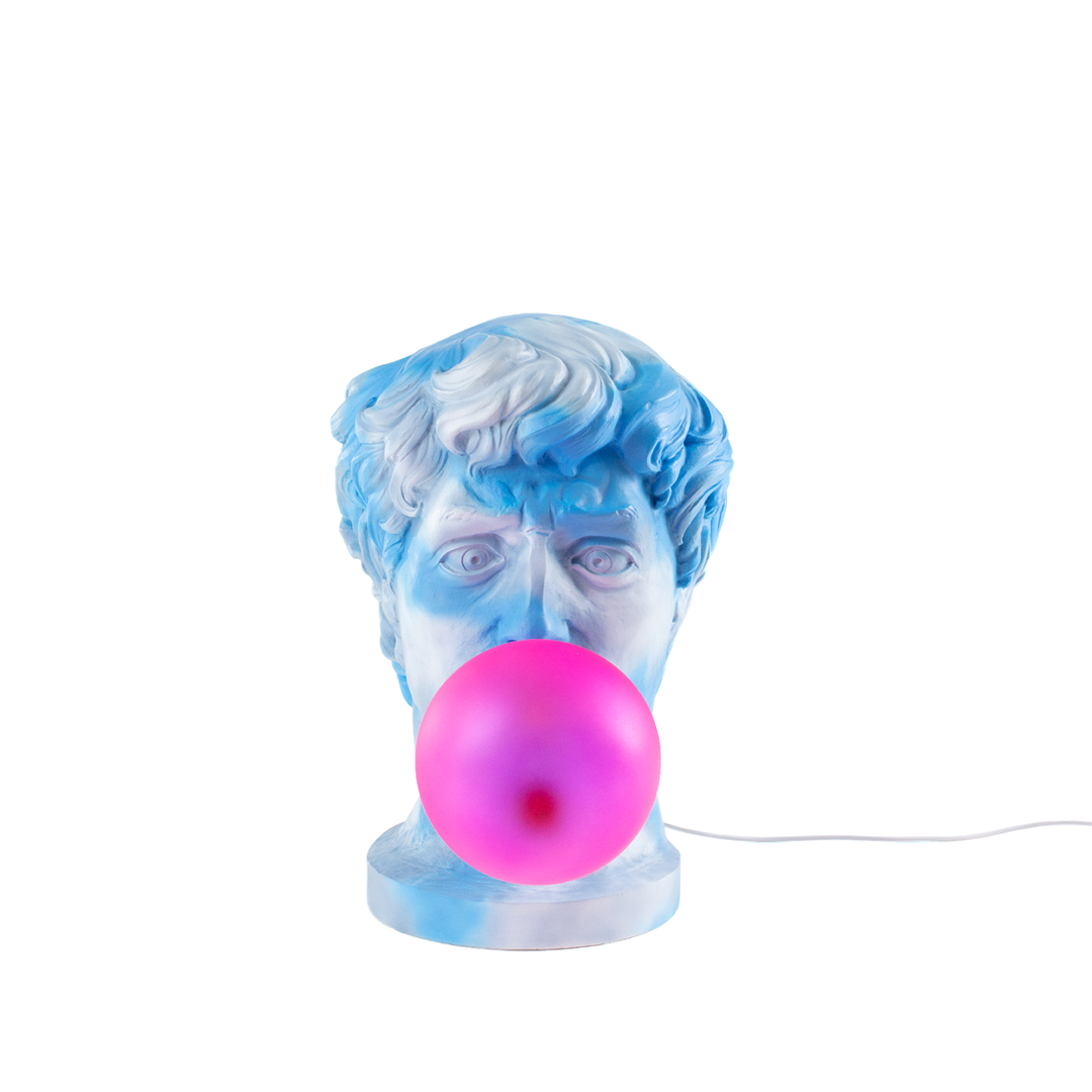 Seletti Wonder Cloud Bust Lamp, resin bust marbled in blue and white clouds blowing a pink bubble, front view