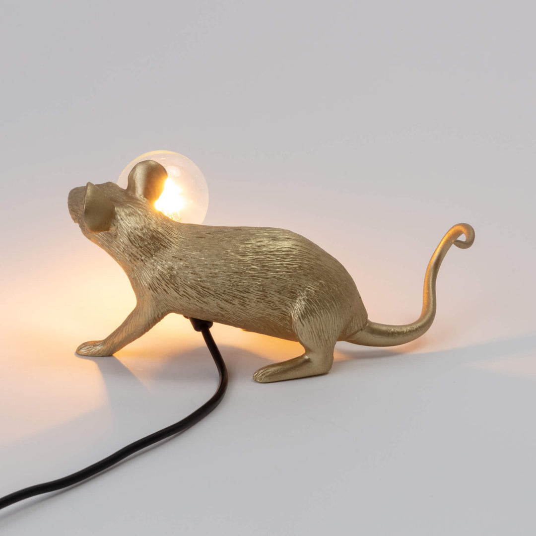 Seletti Mouse Lamp Lop Lying Down Gold, rear three-quarter view with the glowing bulb and curled tail