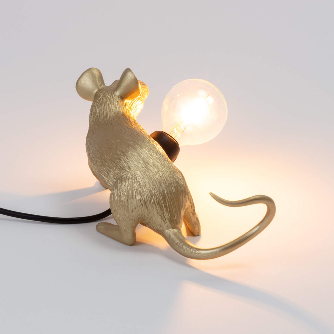 Seletti Mouse Lamp Lop Lying Down Gold, back view of the gold mouse, the lit bulb over its shoulder