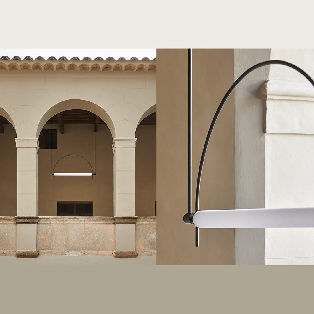 Arc Pendant Lamp in matt black under a stone arcade, with a close-up of the arc meeting the opal tube