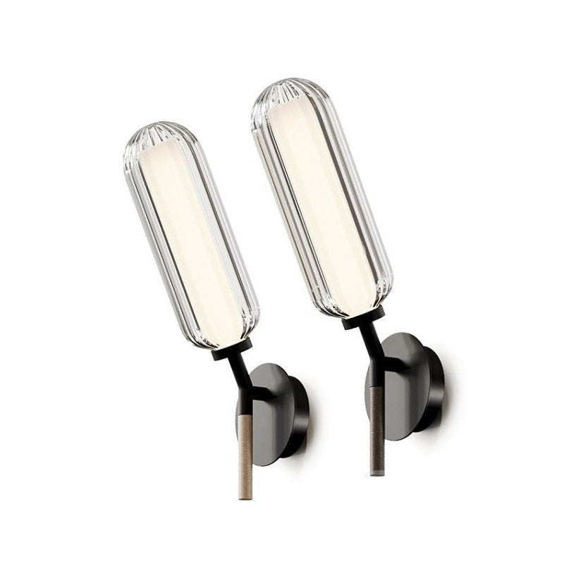 Two lit wall lamps with fluted glass tubes, one with tan leather grip and one with black grip