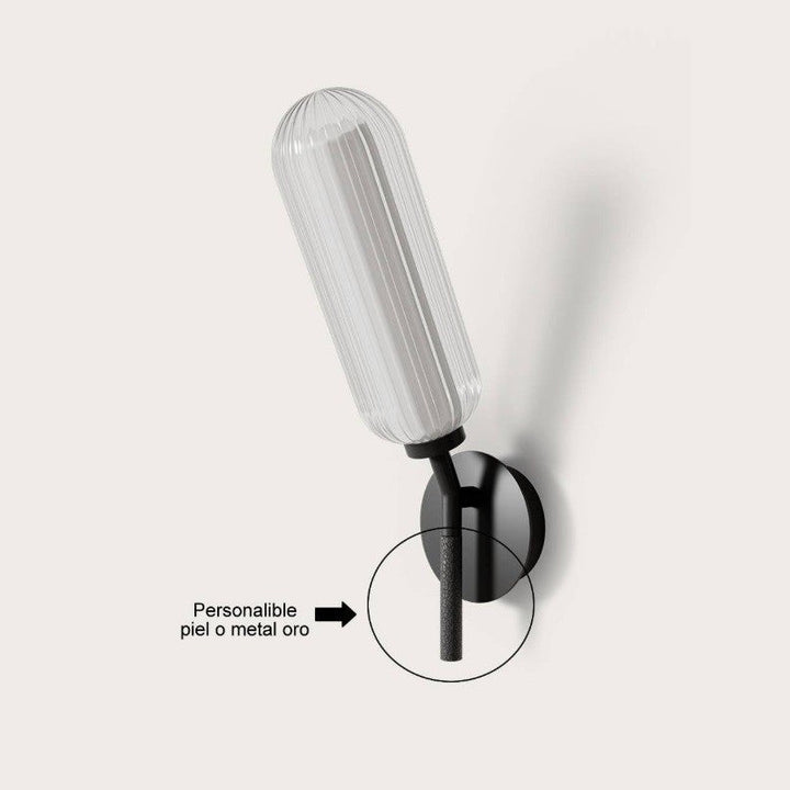 Black wall lamp detail highlighting the grip that can be finished in leather or gold metal