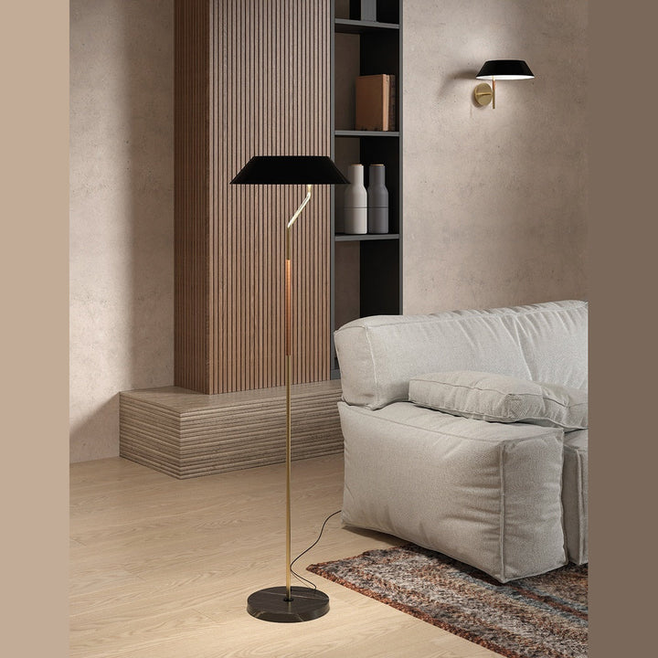 Aider Floor Lamp next to a pale floor sofa by a slatted wood wall, with matching wall lamp