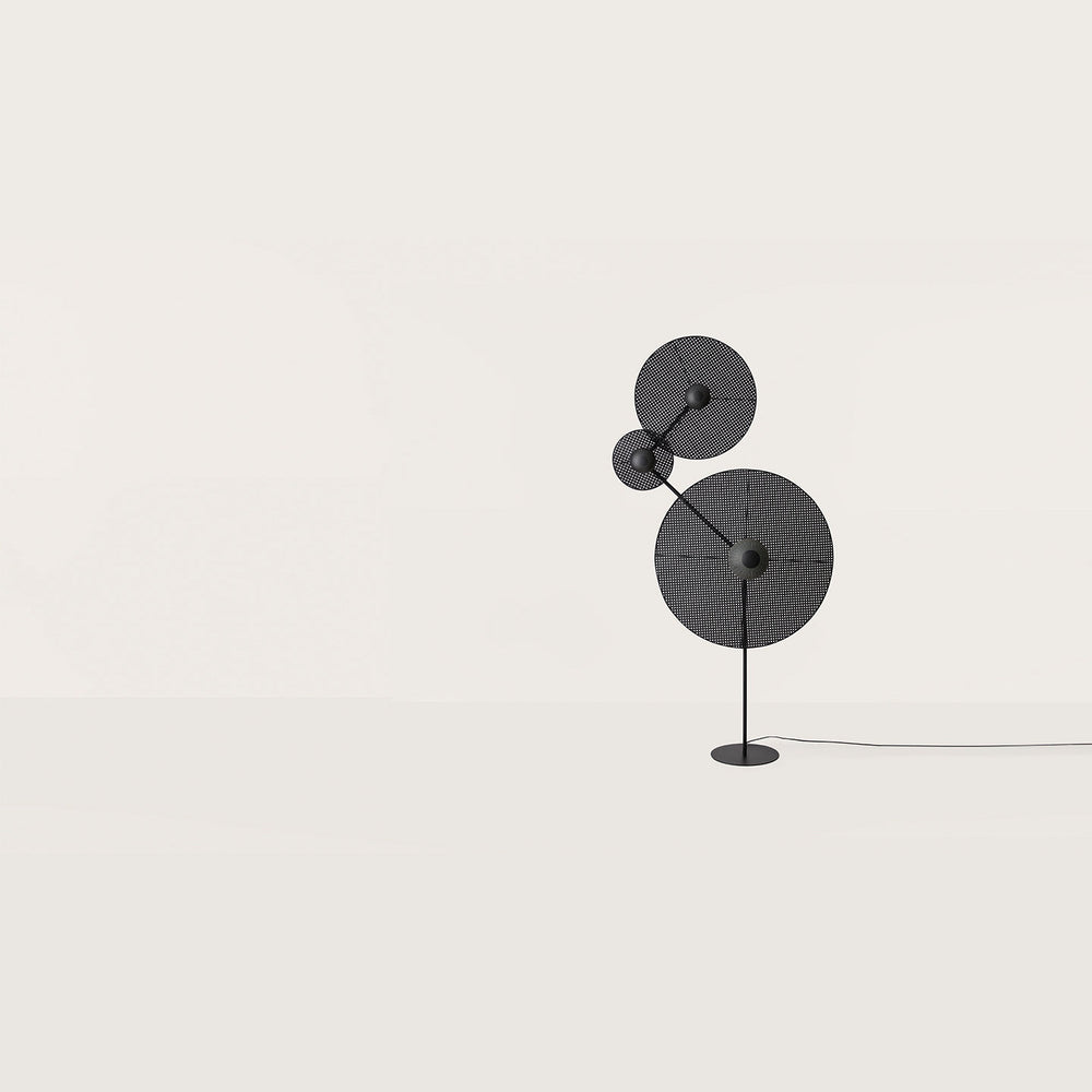Artic Floor Lamp Without Discs, matt black frame shown with perforated round discs, by Aromas del Campo