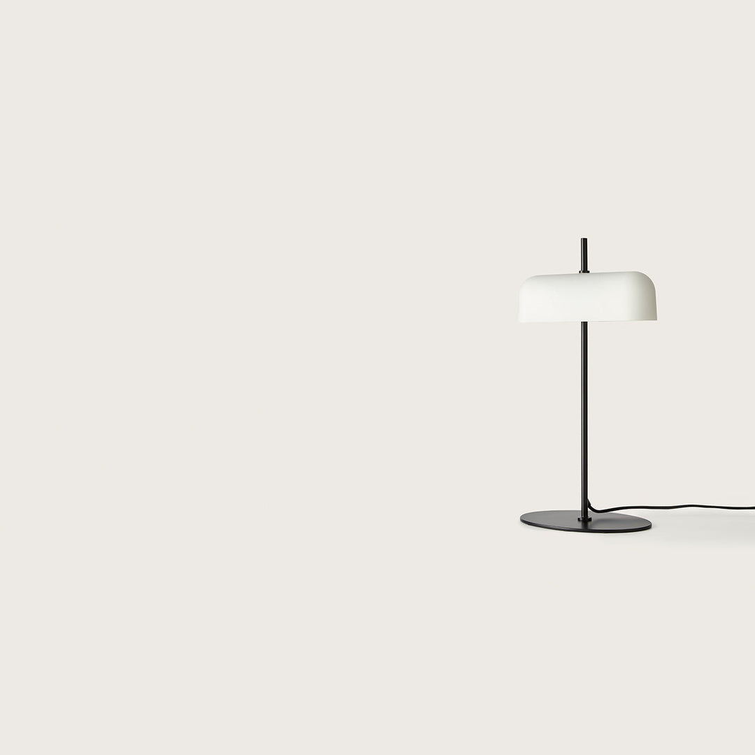 Atil Table Lamp with white rounded metal shade on a slim matt black stem and oval base, by Aromas del Campo
