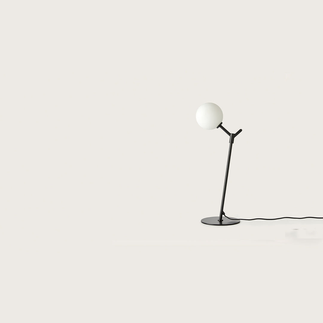 Atom Table Lamp in matt black with an opal glass globe on a slim angled stem and disc base, unlit, by Aromas del Campo