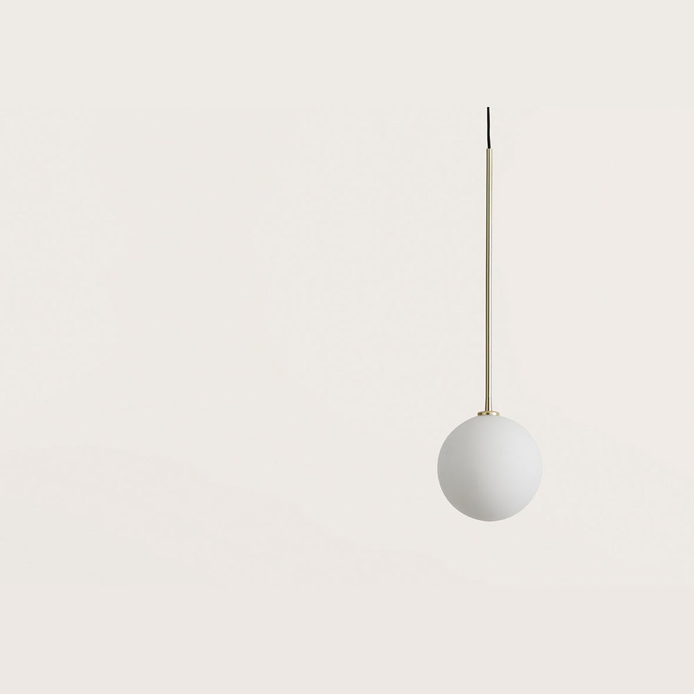 Ball Pendant Lamp close-up of the opal glass globe and matt brass rod