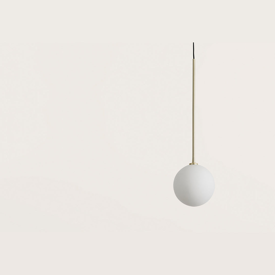 Ball Pendant Lamp close-up of the opal glass globe and matt brass rod