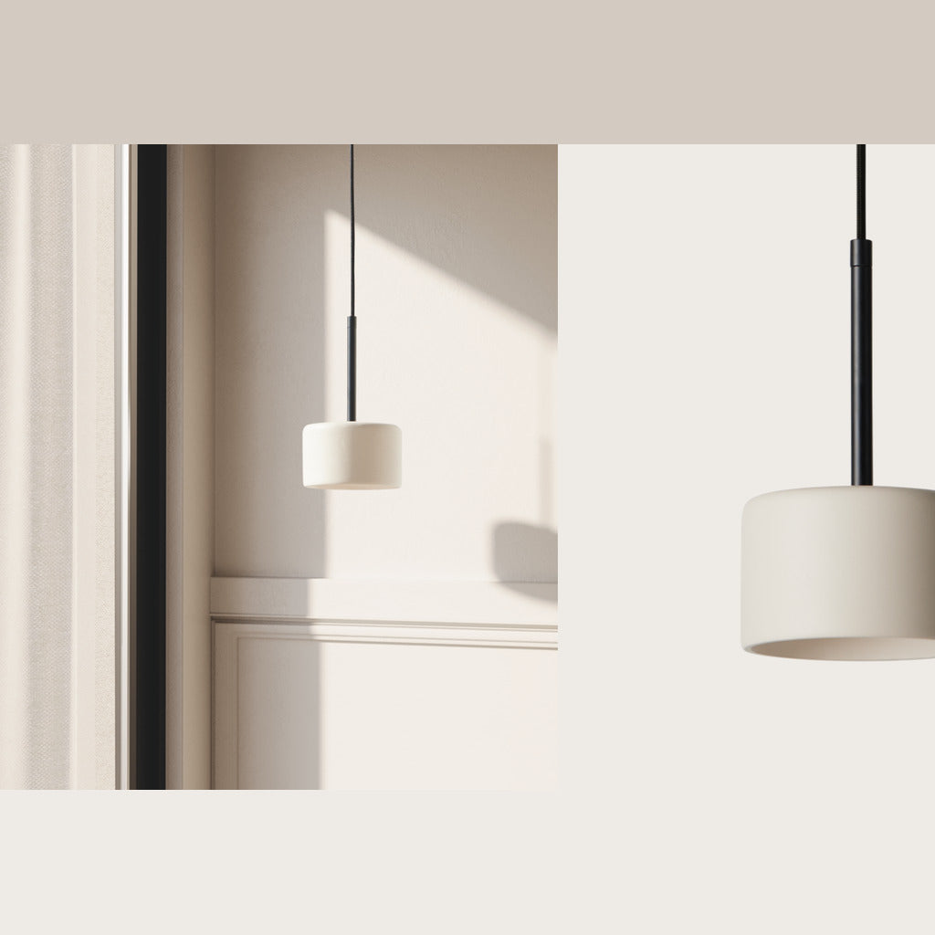 Cora Pendant Lamp in beige and black hanging by a sunlit window
