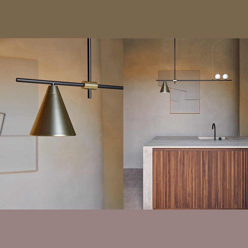 Crane Linear Pendant brass cone shade above a kitchen with fluted wood island and plaster walls