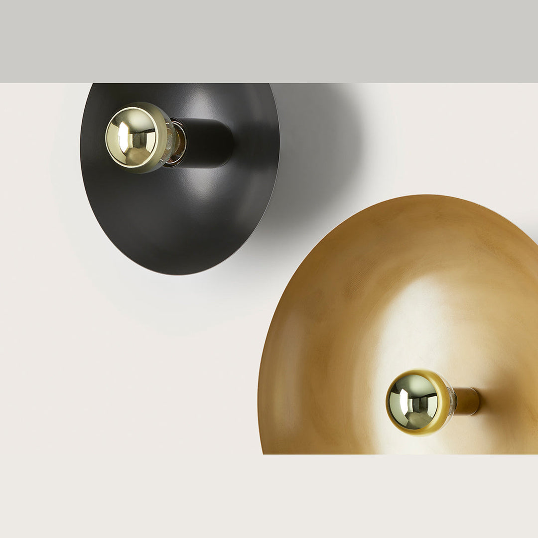 Cropi 25 Wall Lamp close-up of black and aged gold dishes with gold-capped bulbs