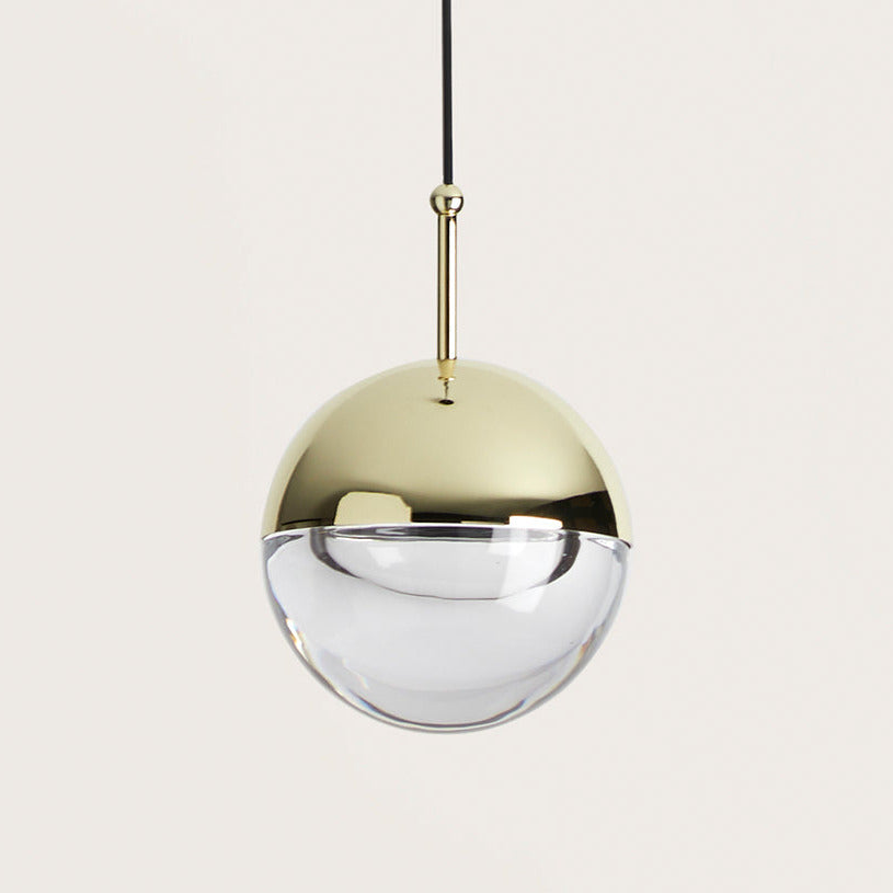 Dora Pendant Lamp close-up, shiny gold upper half and clear optic glass lower half