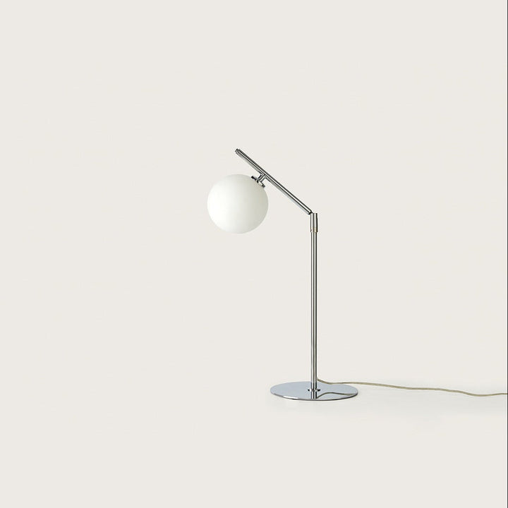 Endo Table Lamp in chrome with angled arm and opal glass globe, unlit, by Aromas del Campo