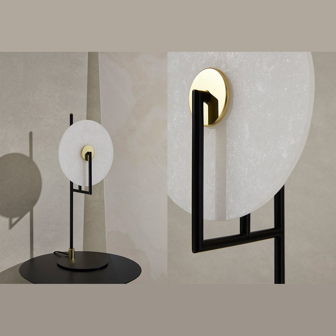 Alabaster disc table lamp with black frame shown beside a close view of its brass bulb holder