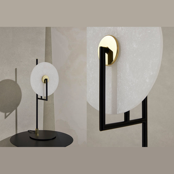 Alabaster disc table lamp with black frame shown beside a close view of its brass bulb holder
