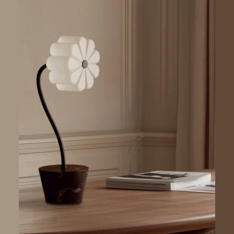 Flow Table Lamp with opal glass flower shade on a curved black stem and dark pot base, by Aromas del Campo