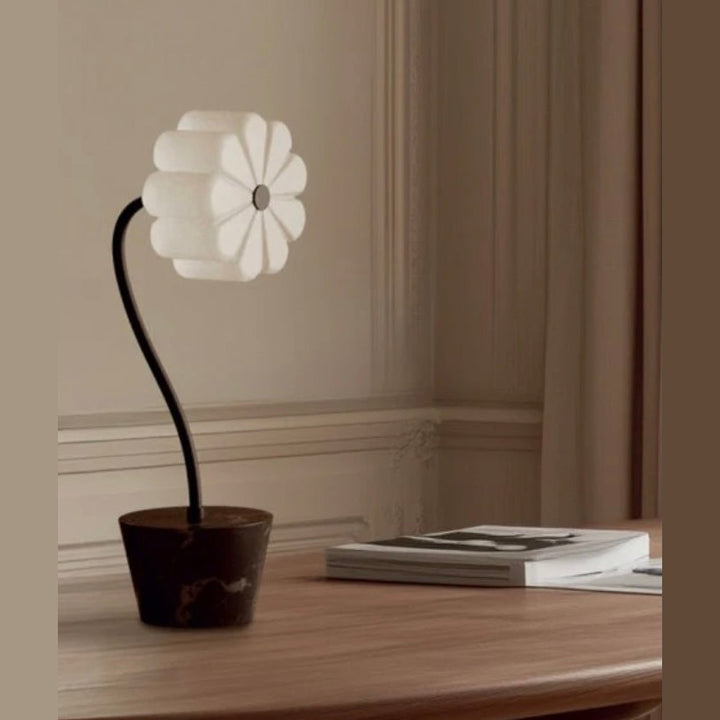 Flow Table Lamp with opal glass flower shade on a curved black stem and dark pot base, by Aromas del Campo