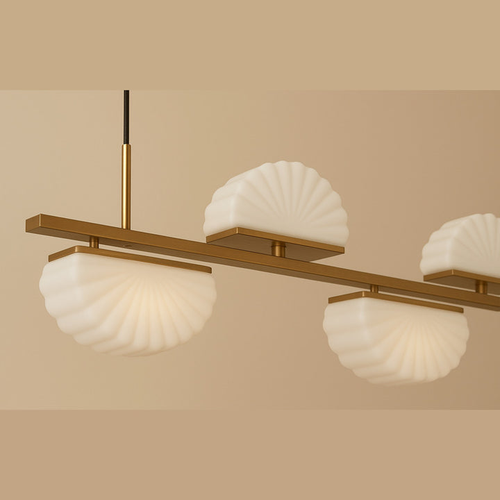 Gina Linear Pendant Linear Pendant in gold, lit, close-up of opal shell shades on the bar