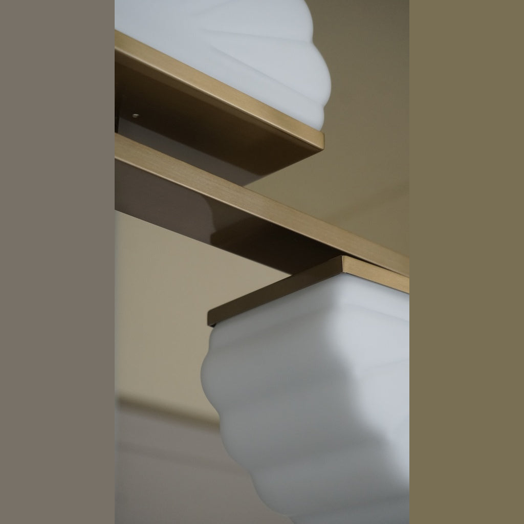 Gina Linear Pendant Linear Pendant detail of a ribbed opal glass shade under a gold bracket