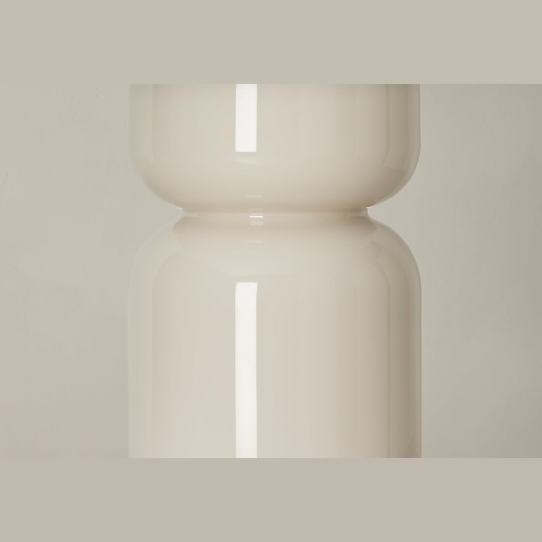 Close view of the curved glossy cream glass base