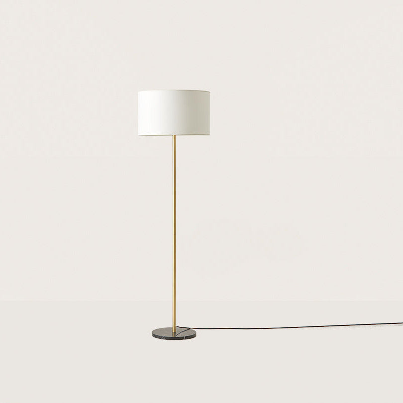 Hedra Floor Lamp with a slim brass stem, black marble base and white drum shade, unlit, by Aromas del Campo