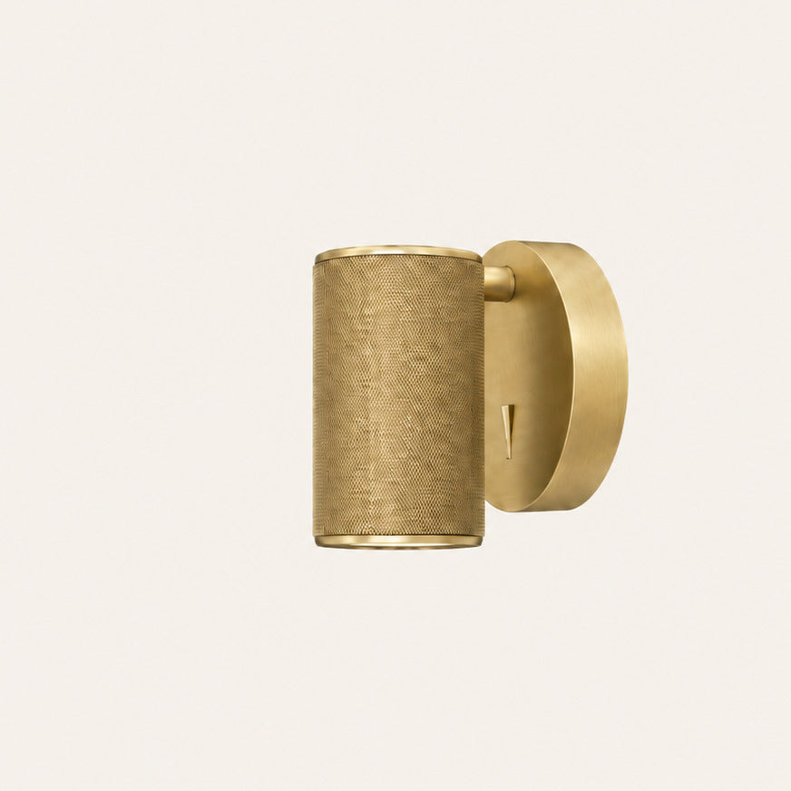 Latto Wall Lamp in Aged Gold, side view of the knurled cylinder shade and round canopy, unlit