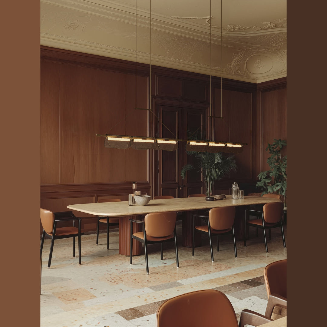 Two linear pendants hung over a long dining table in a wood-panelled dining room