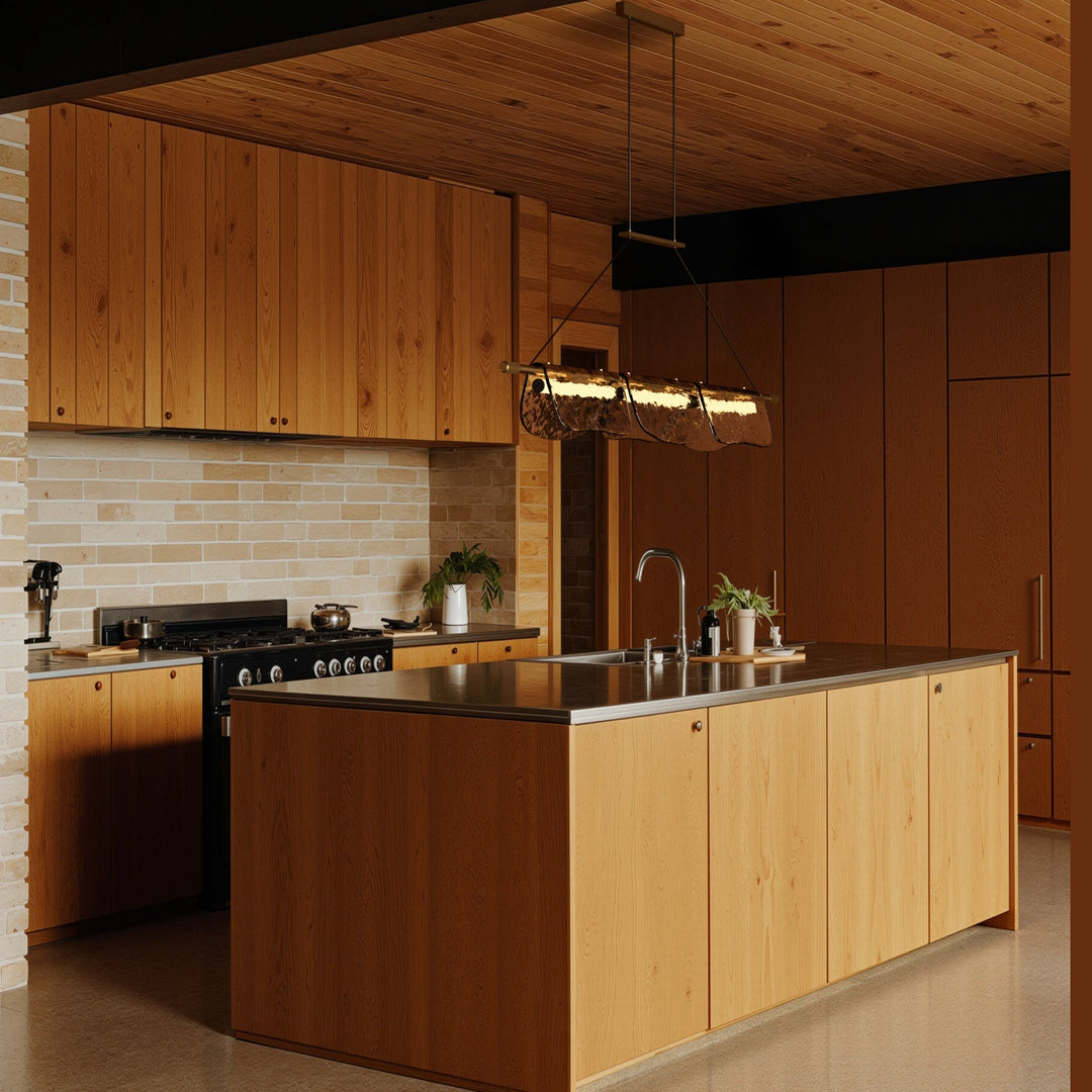 Linear pendant lit over a wood kitchen island with warm timber cabinets and ceiling